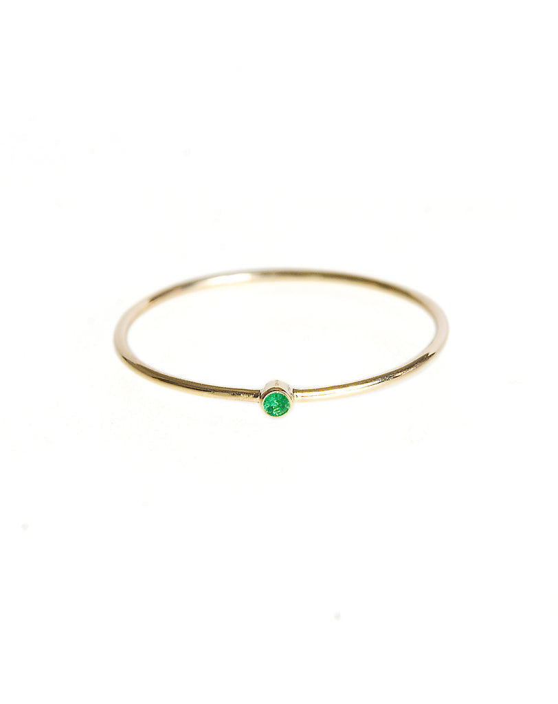 Thin stack ring with emerald
